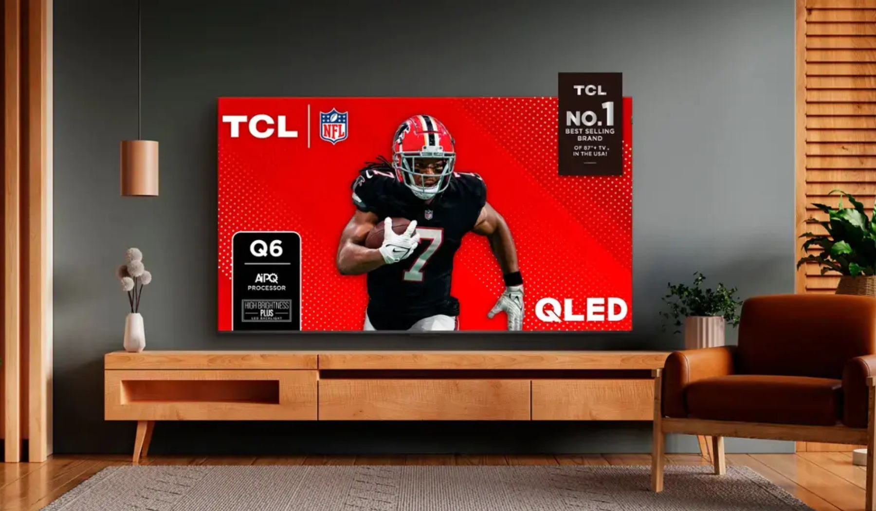 Living room scene featuring TV stand with TCL TV with football player on screen