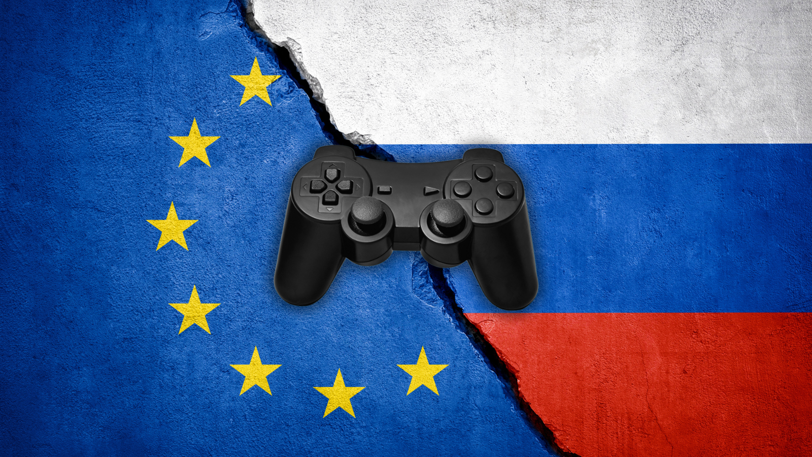 EU and Russian flags on a wall, with a crack dividing them. A video game controller has been superimposed on top of them in the centre of the image.