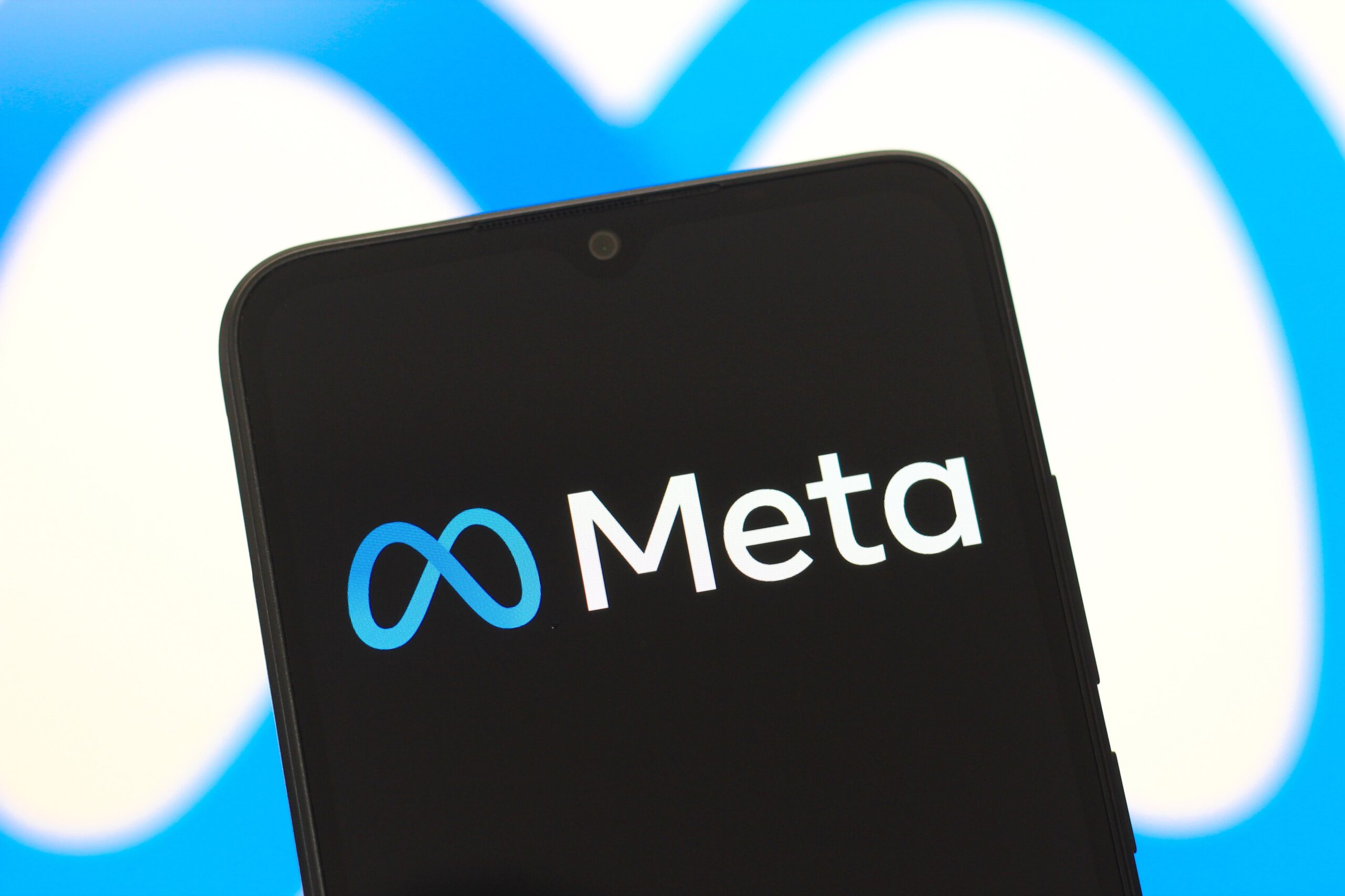 The Meta Platforms, Inc. logo is seen displayed on a smartphone screen.