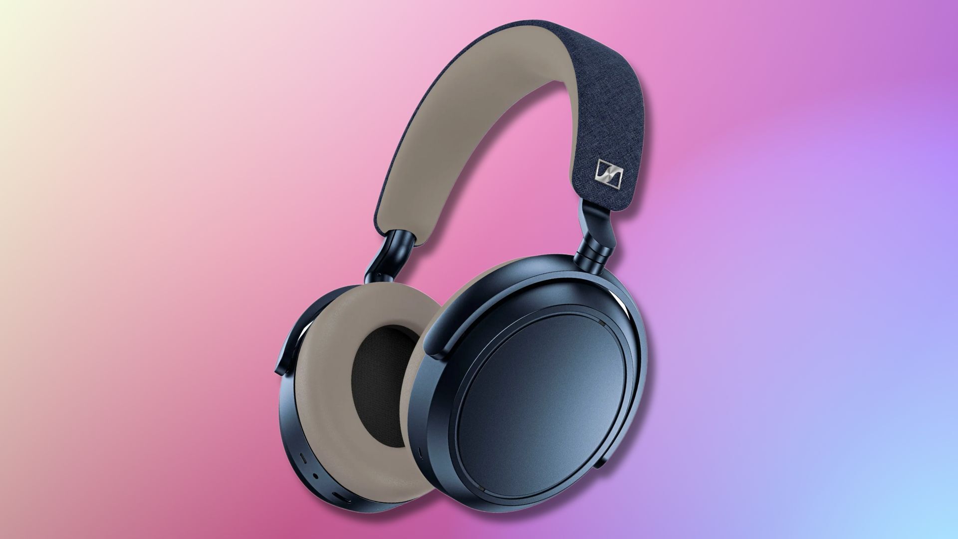 sennheiser momentum 4 denim colored headphones on a purple, pink, and yellow gradient background