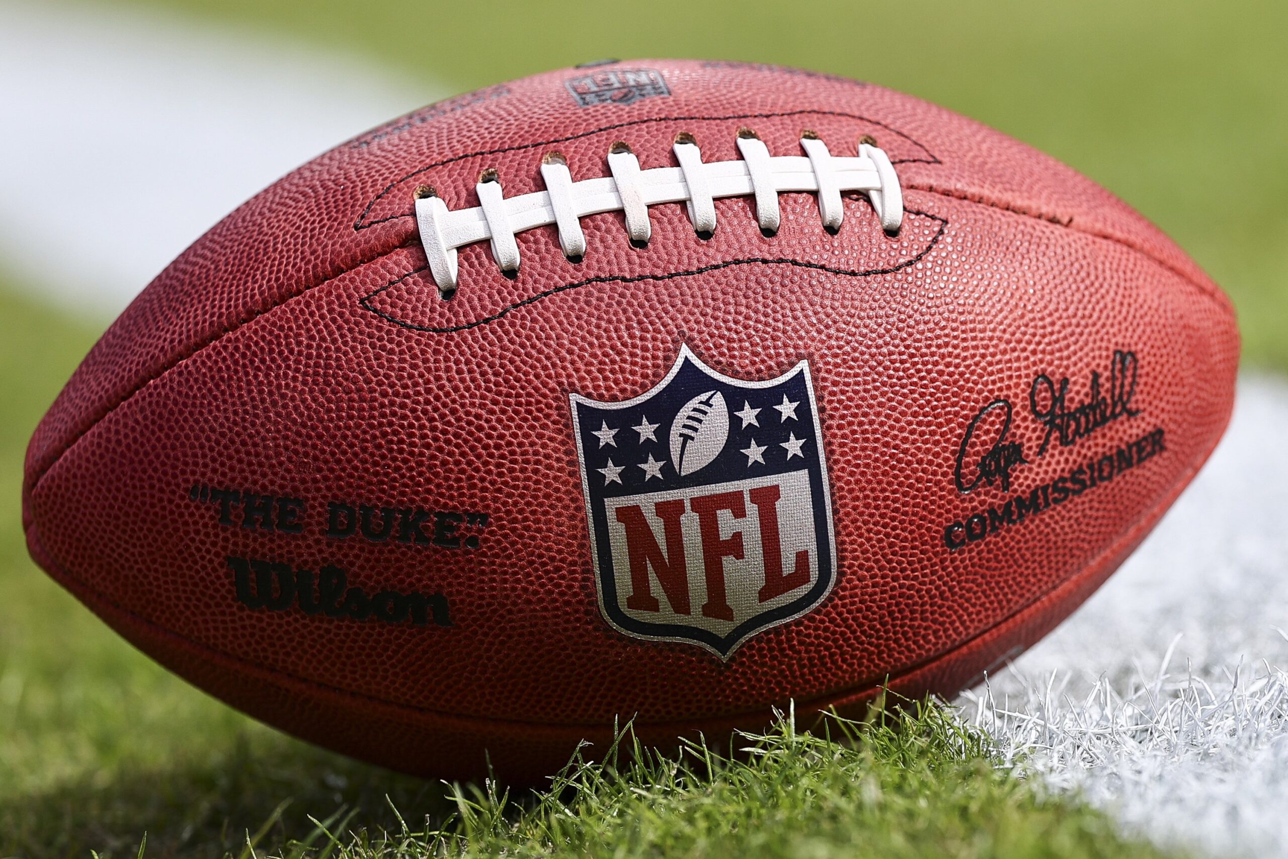 A detail of the NFL Shield logo on a game ball