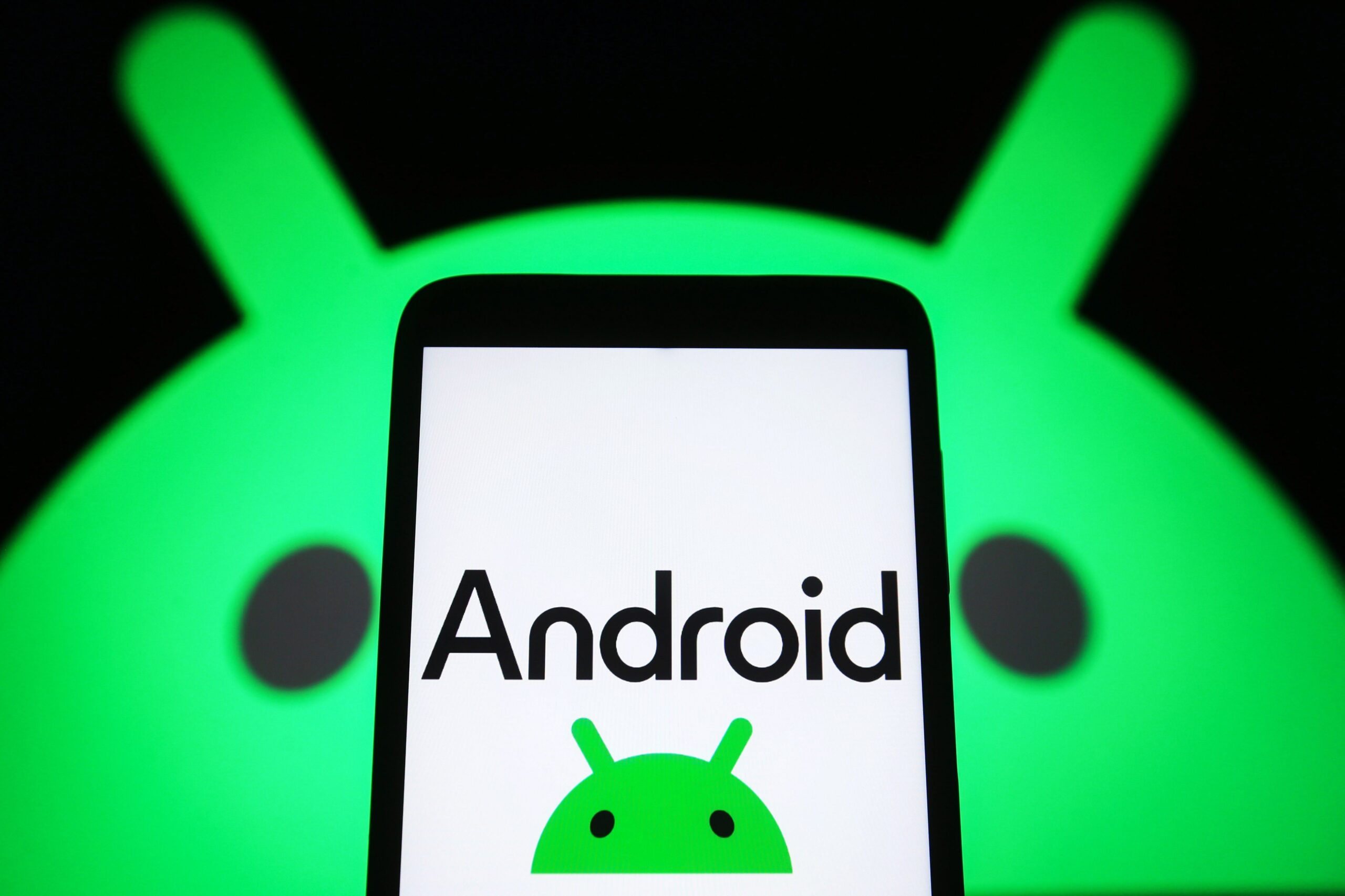 android logo on a phone with the logo behind the phone as well