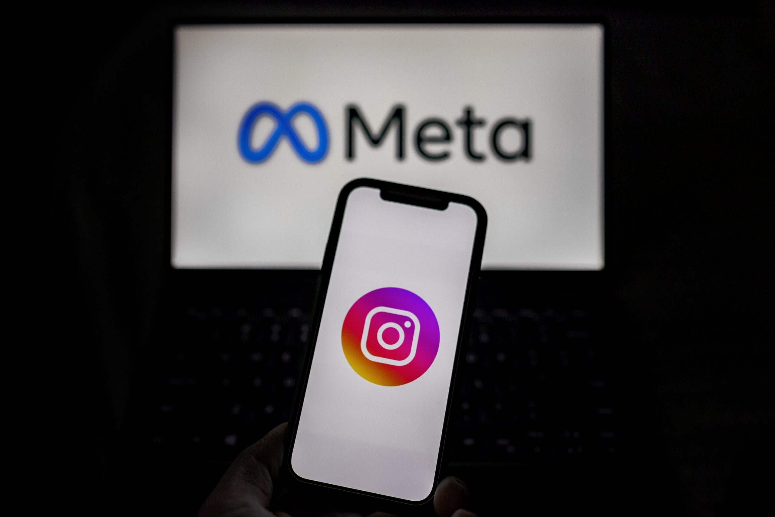 Meta and Instagram logos are seen on screens 