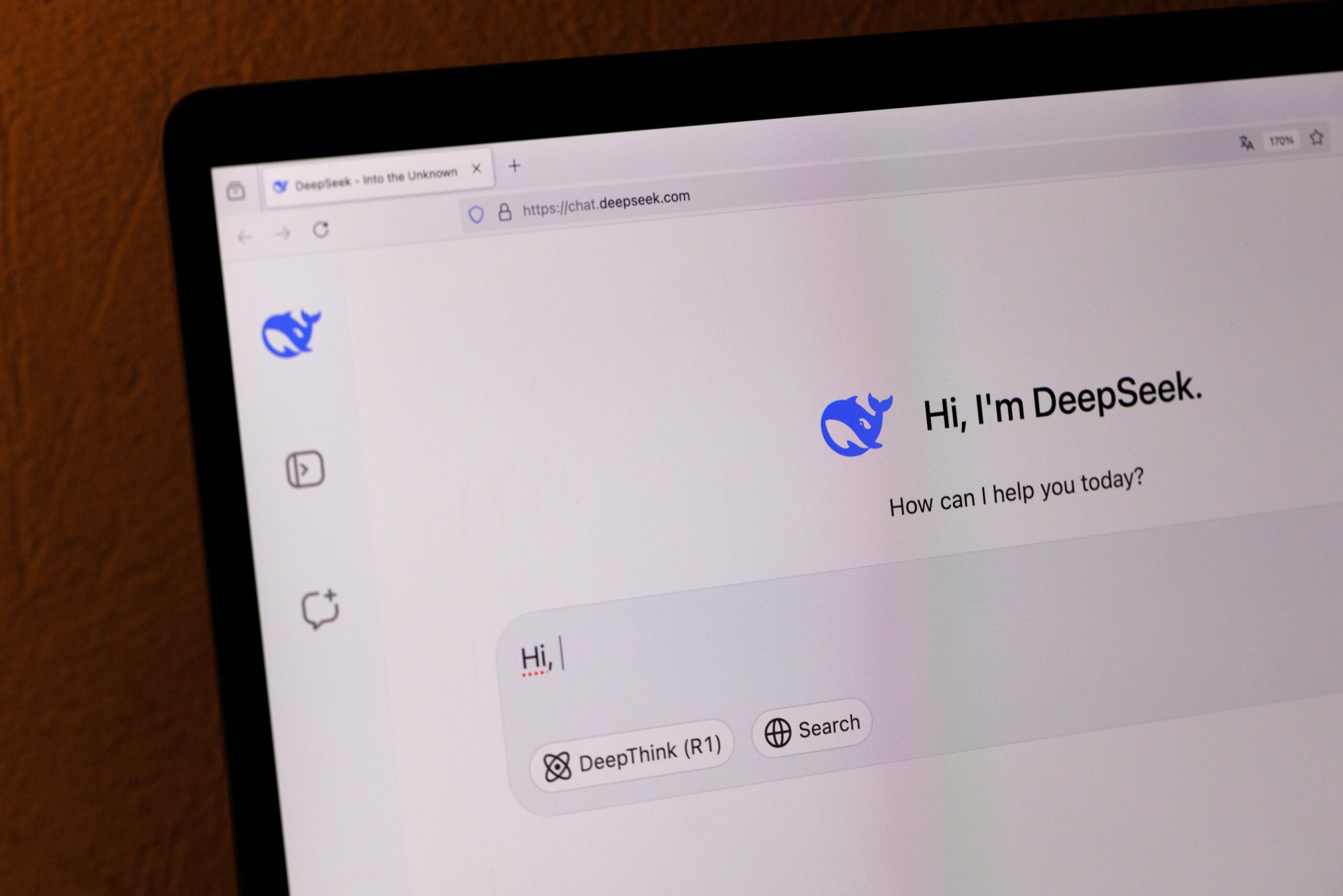 A desktop computer shows the DeepSeek chatbot homepage.