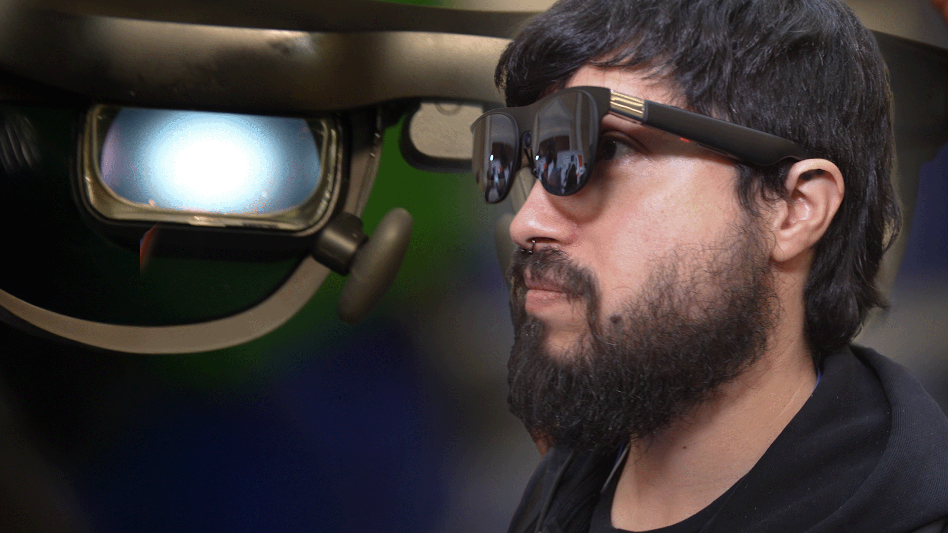 a profile view of a man wearing xreal's AR glasses