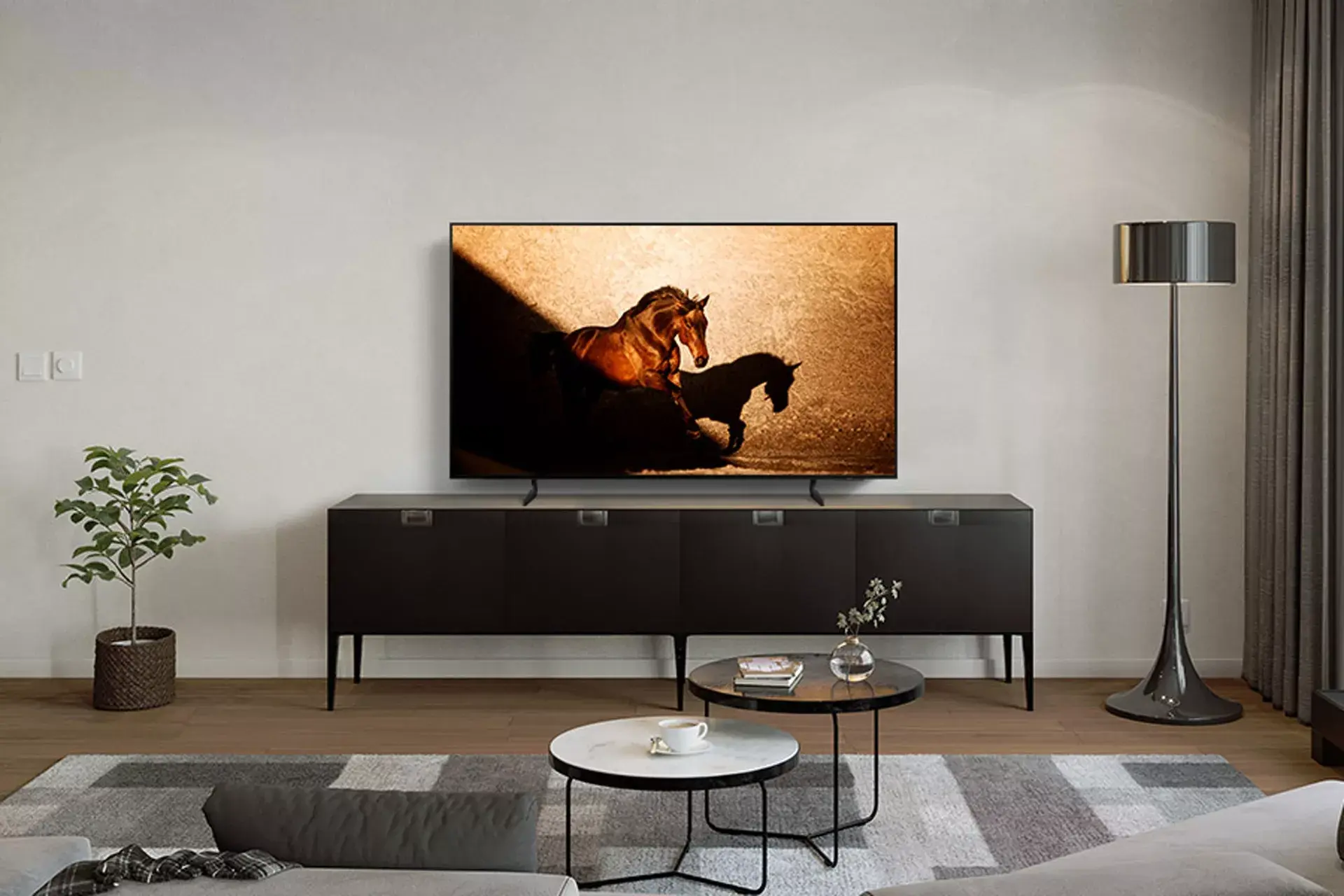 Samsung OLED TV with horse screensaver sitting on TV stand in living room setup