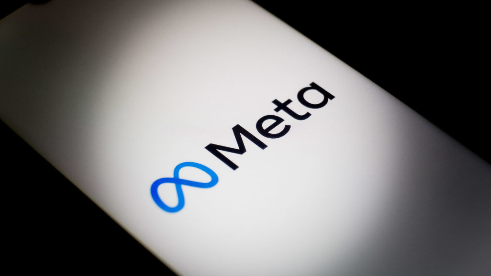 The Meta logo is displayed on a smartphone screen.