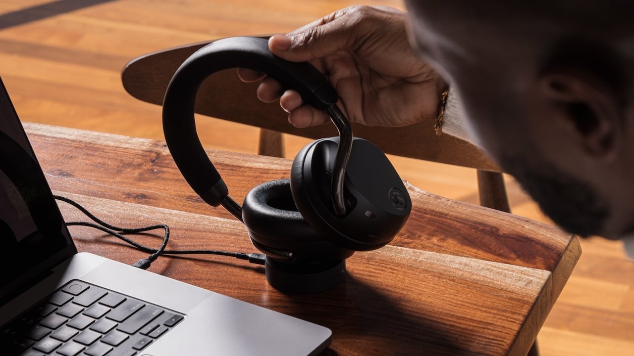 Person holding JLab Epic Lux Lab Edition headphones