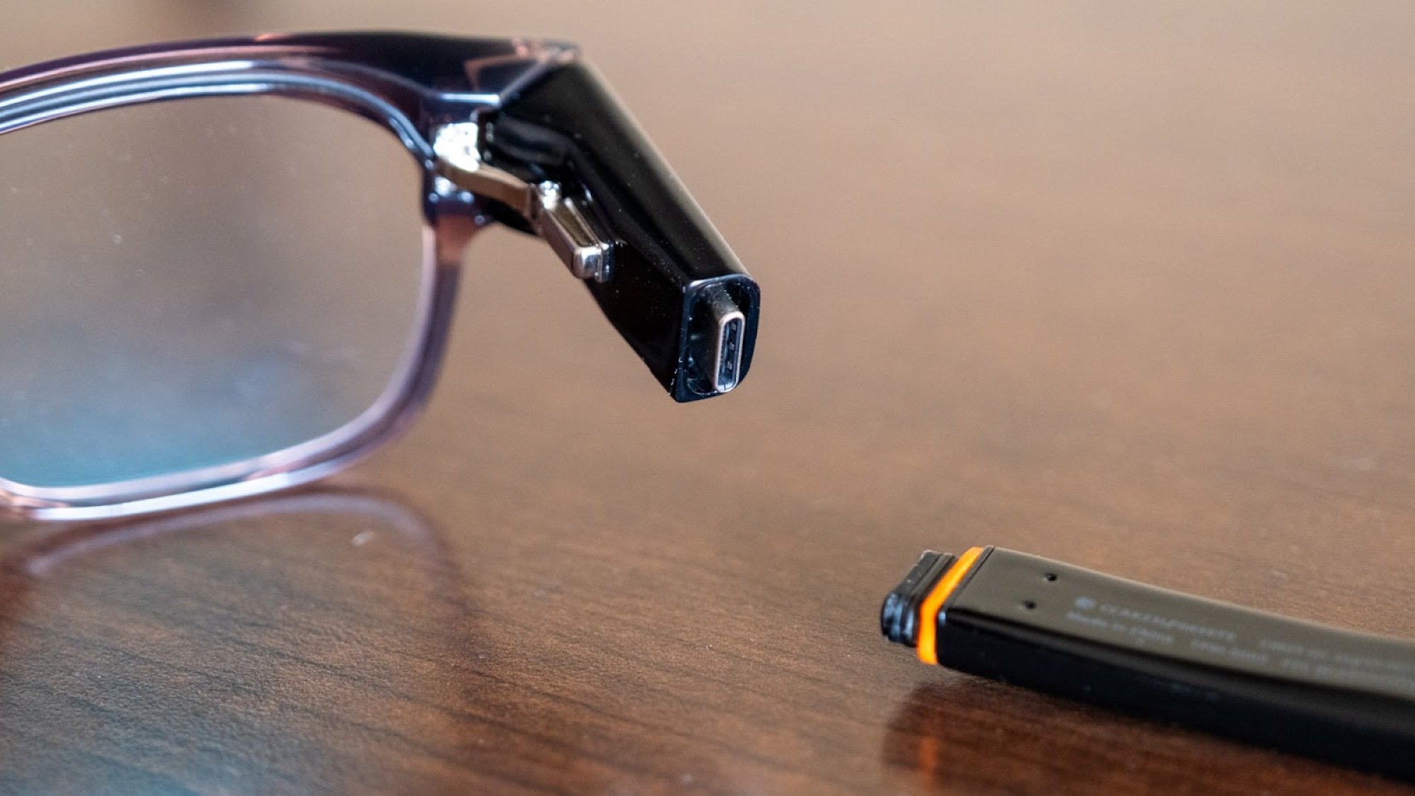 The Solos AirGo Vision smart glasses on a table. 