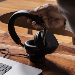 Person holding JLab Epic Lux Lab Edition headphones