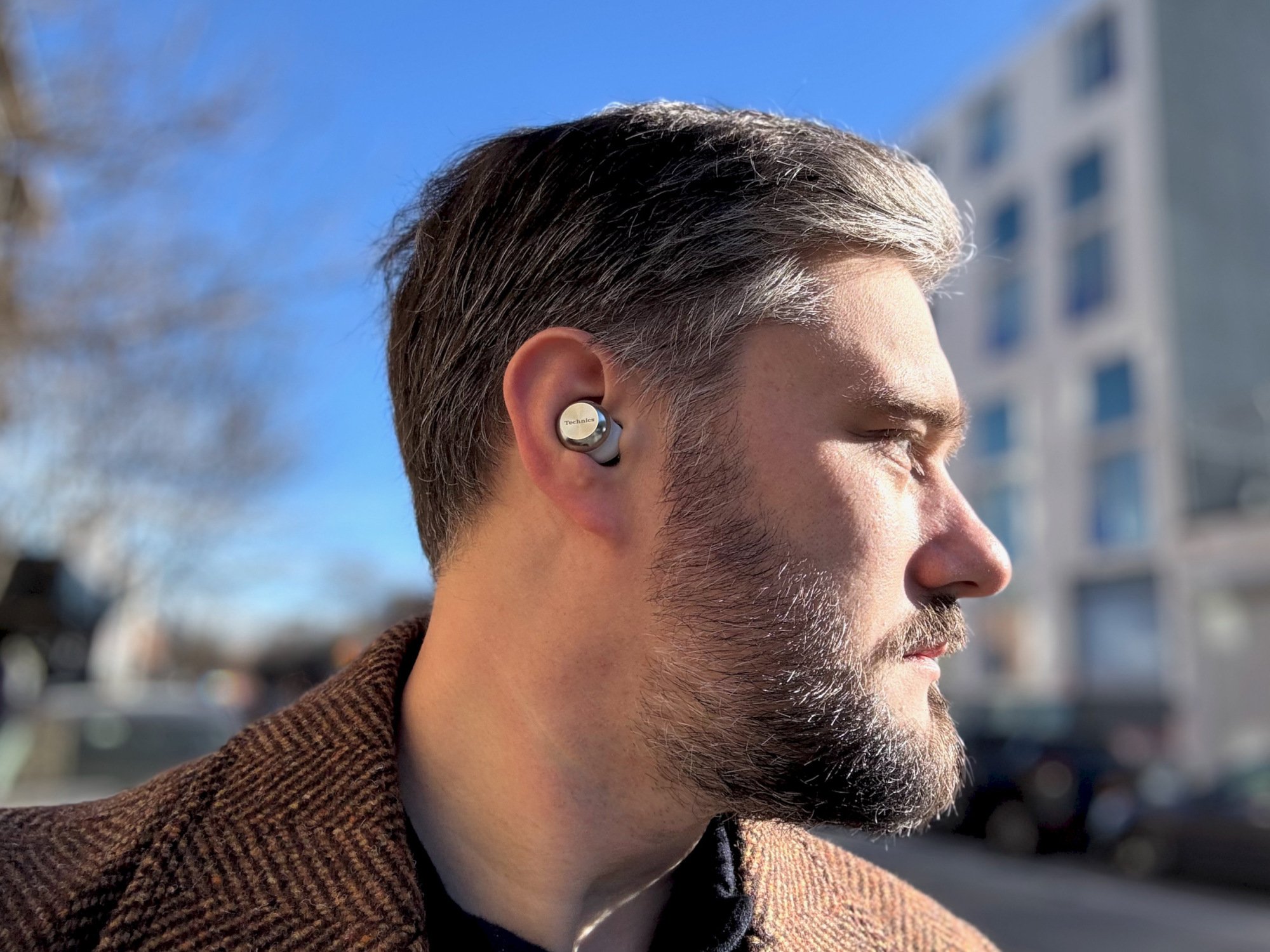 timothy beck werth, a very handsome man, wearing the technics az100 wireless earbuds