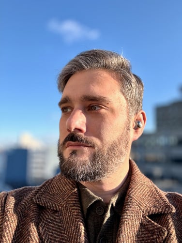 the author wearing the technics az100 wireless earbuds