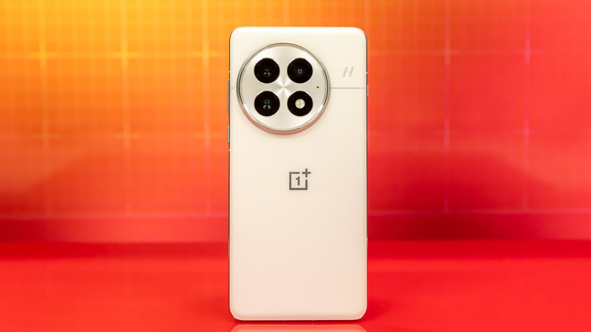 OnePlus 13 rear against an orange background