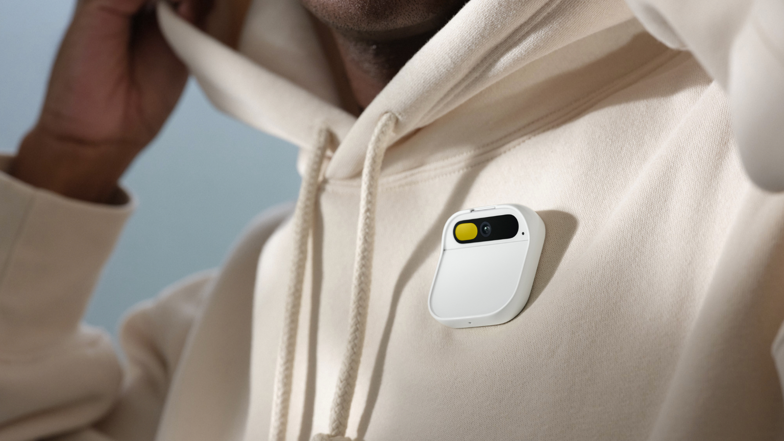 Humane's Ai Pin on someone wearing a white hoodie.