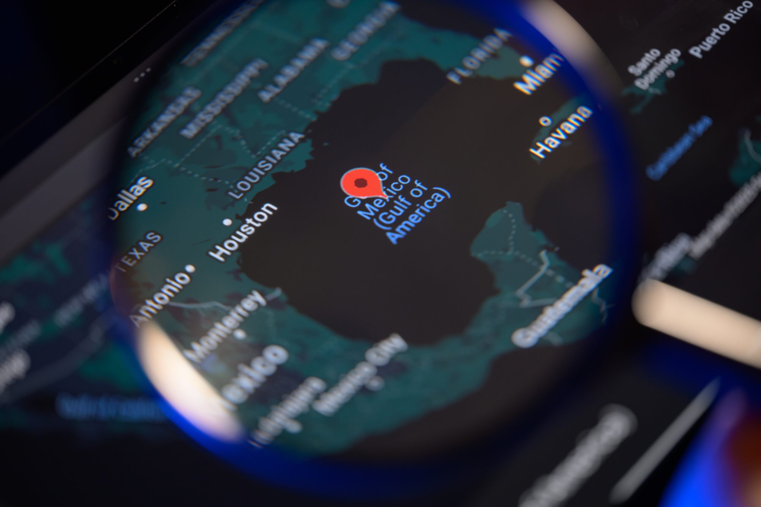 A magnifying glass zooms in on the new Gulf of America label in Apple maps.