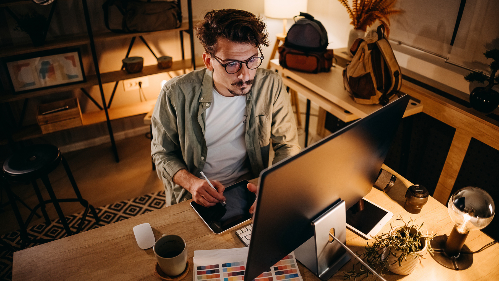 Graphic designer works in his office - stock photo