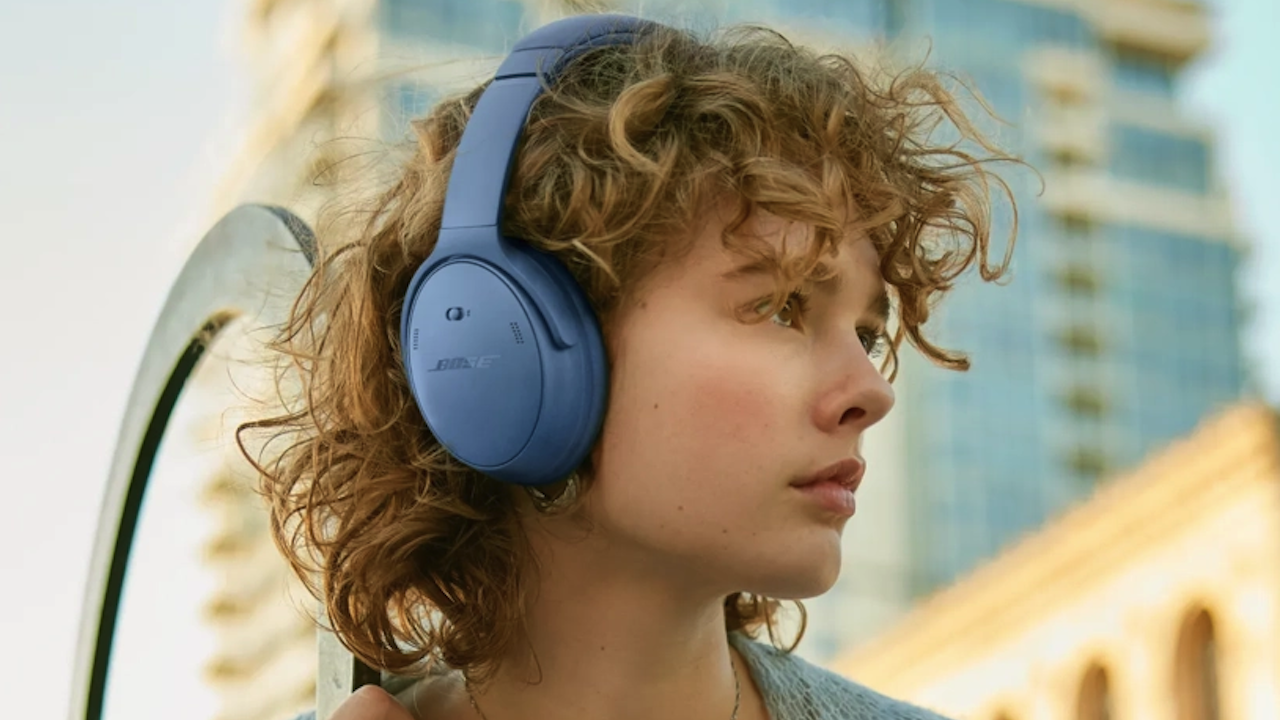 Person wearing Bose QuietComfort headphones 