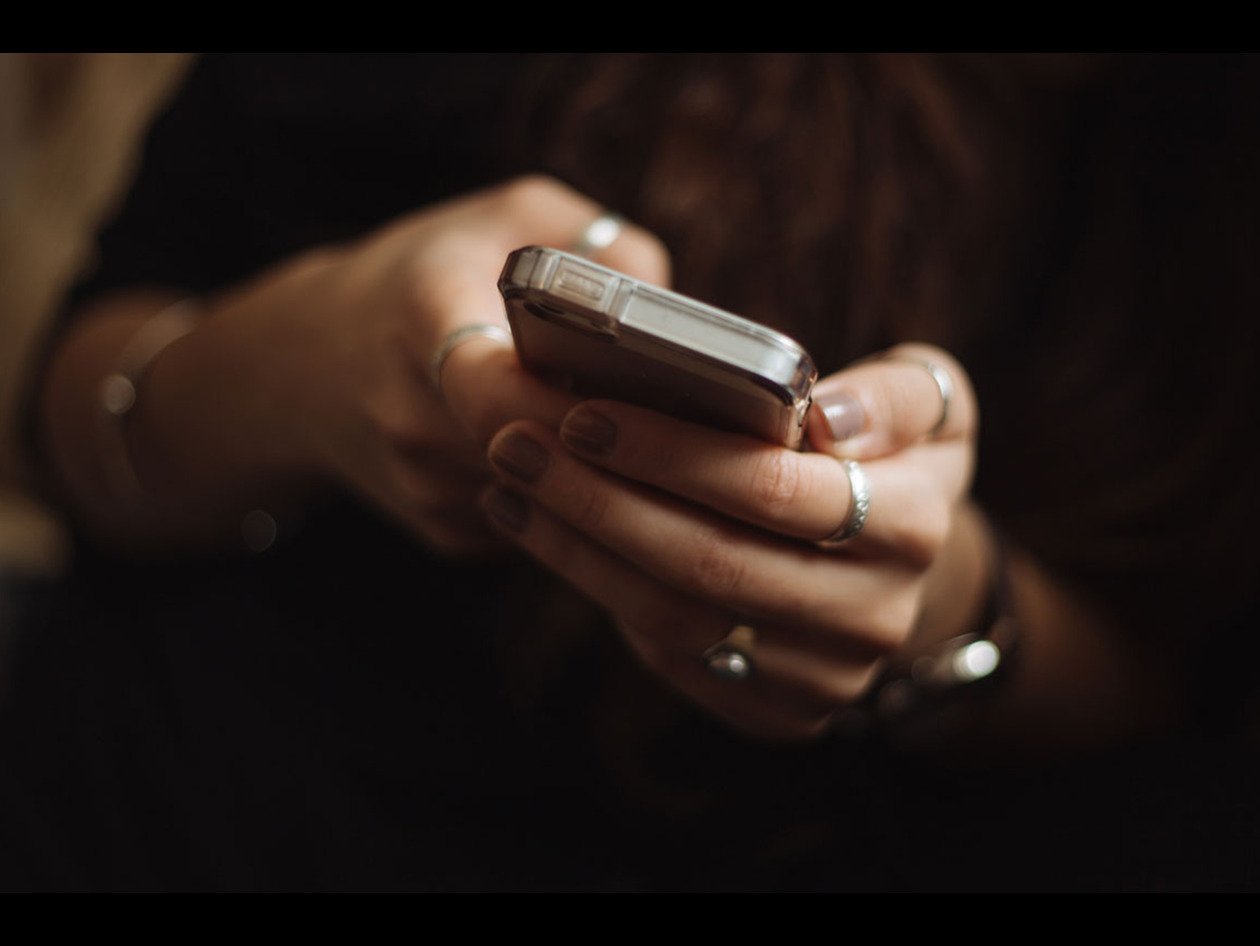 close-up of woman holding smartphone in her hands