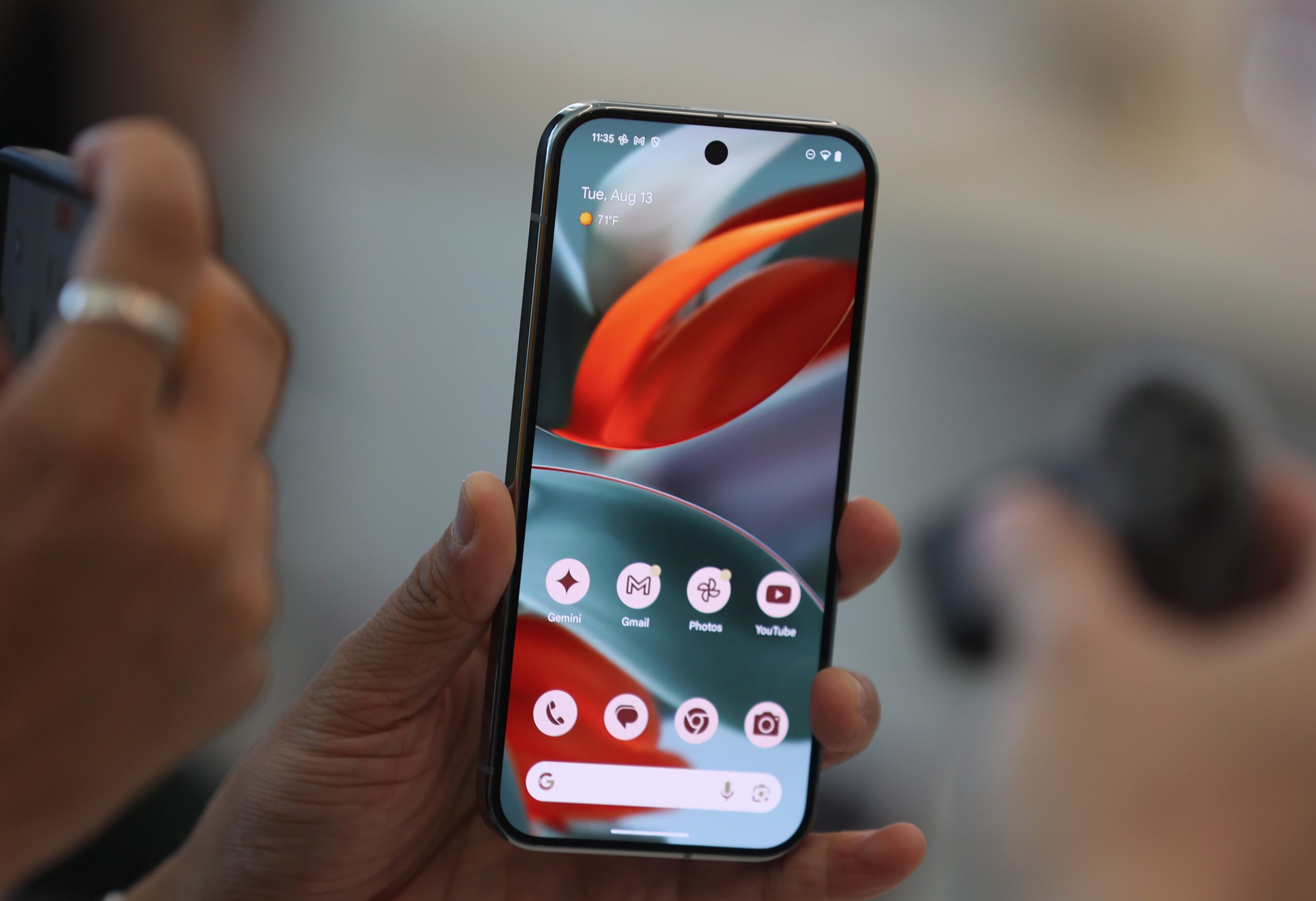  An attendee looks at a new Google Pixel 9 phone during the Made By Google event at Google headquarters on August 13, 2024 in Mountain View, California