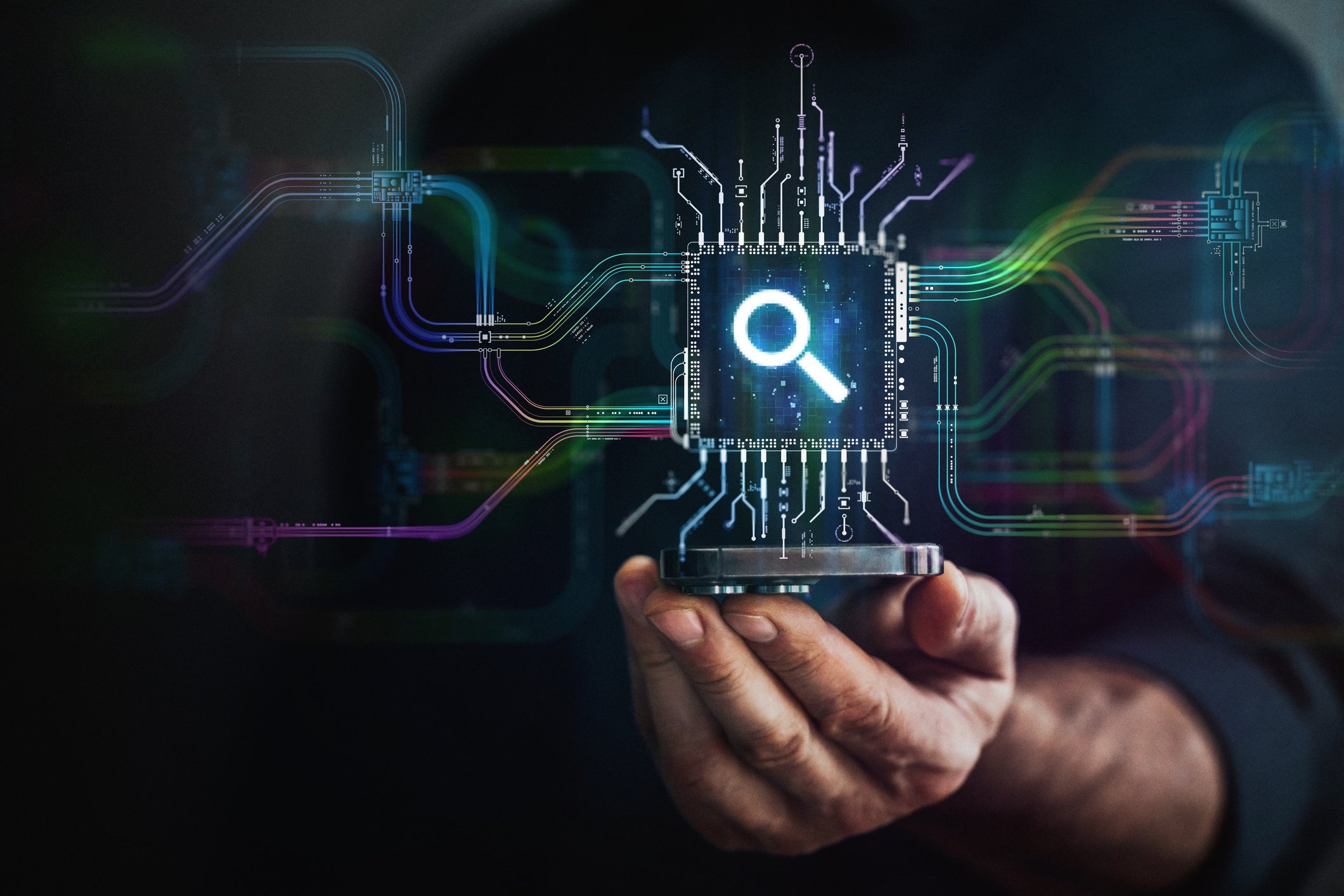 A hand holds digital lens icon in the center and circuit board with vibrant data transfers