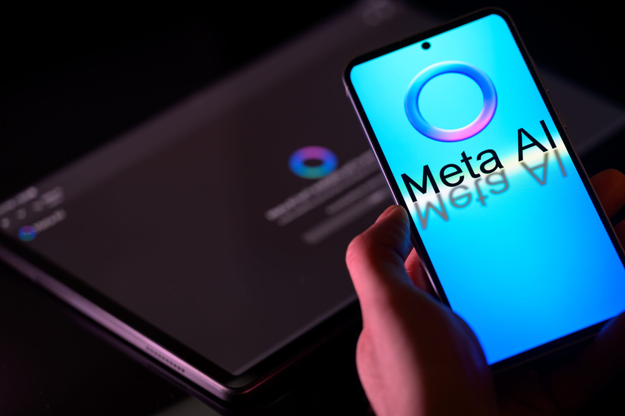 The Meta AI logo is displayed on a mobile phone with the Meta AI app visible on a tablet in this photo illustration in Brussels, Belgium, on January 26, 2025.