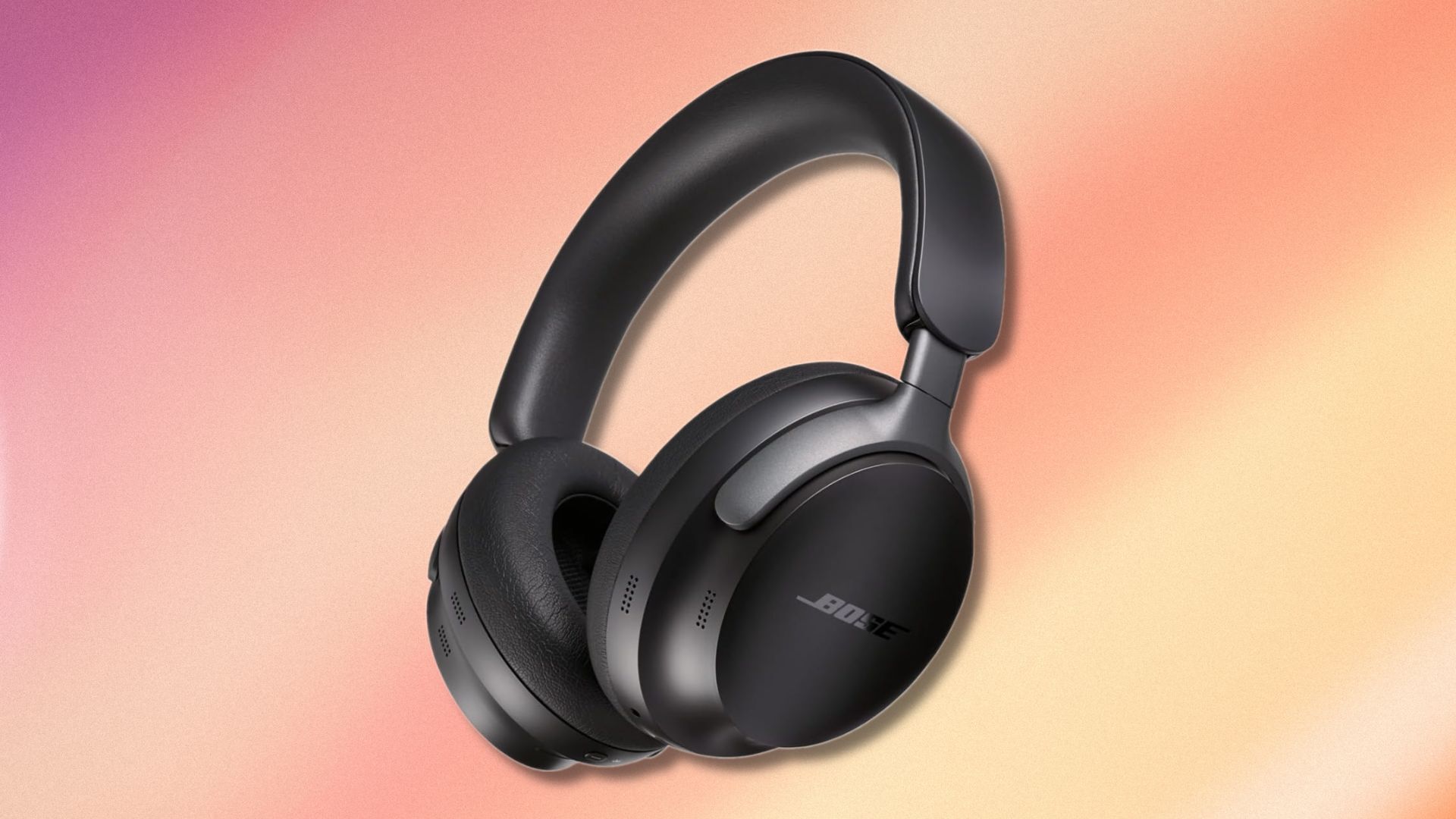 black bose quietcomfort ultra headphones on a purple, yellow, and pink gradient background