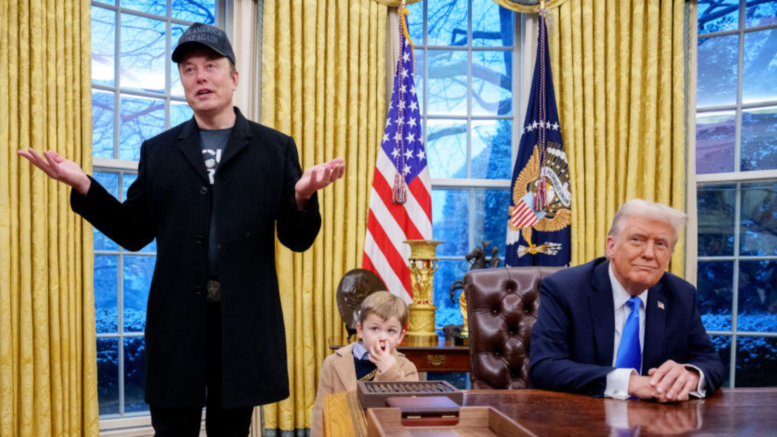 Tesla and SpaceX CEO Elon Musk, accompanied by U.S. President Donald Trump (R), and his son X Musk, speaks during an executive order signing in the Oval Office at the White House on February 11, 2025 in Washington, DC. 