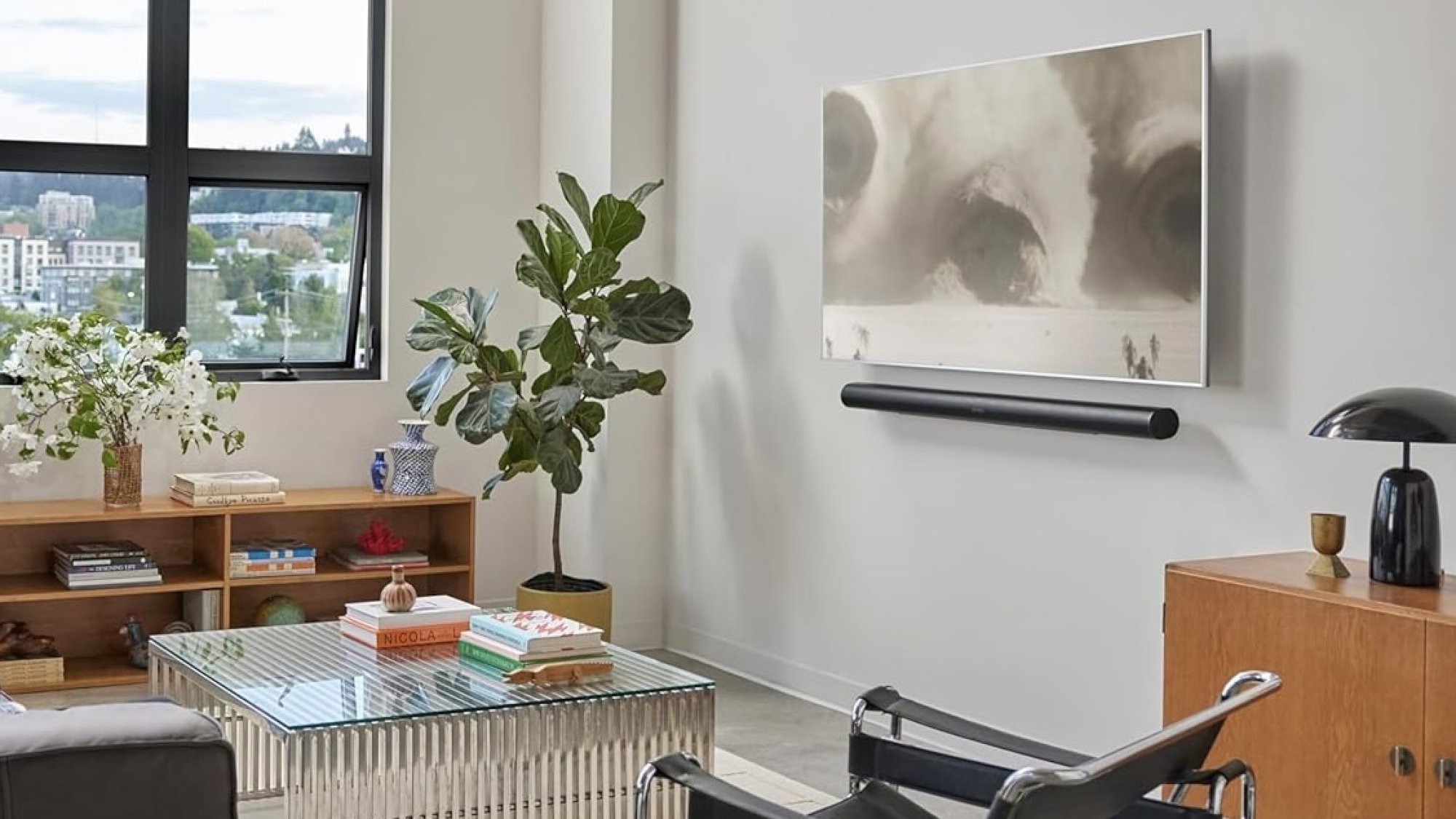 black sonos arc ultra soundbar mounted on wall under TV in living room