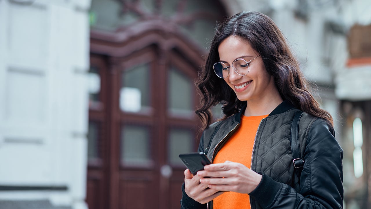 Person looking at phone smiling