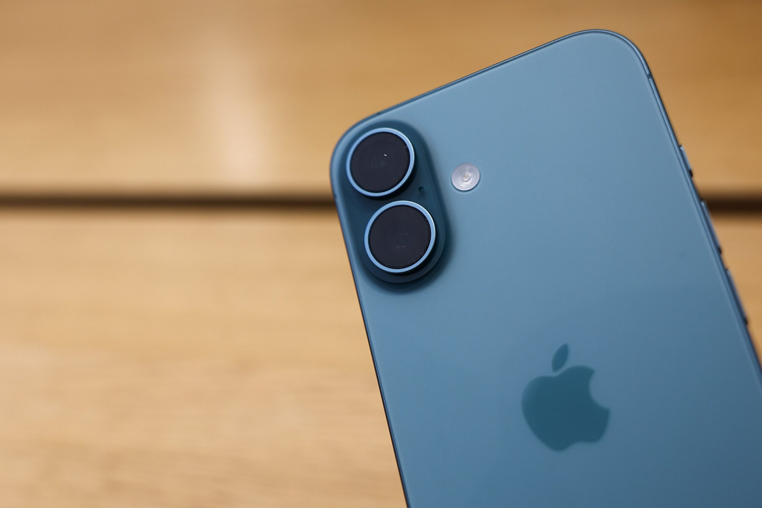 an iphone with a wood table in the background