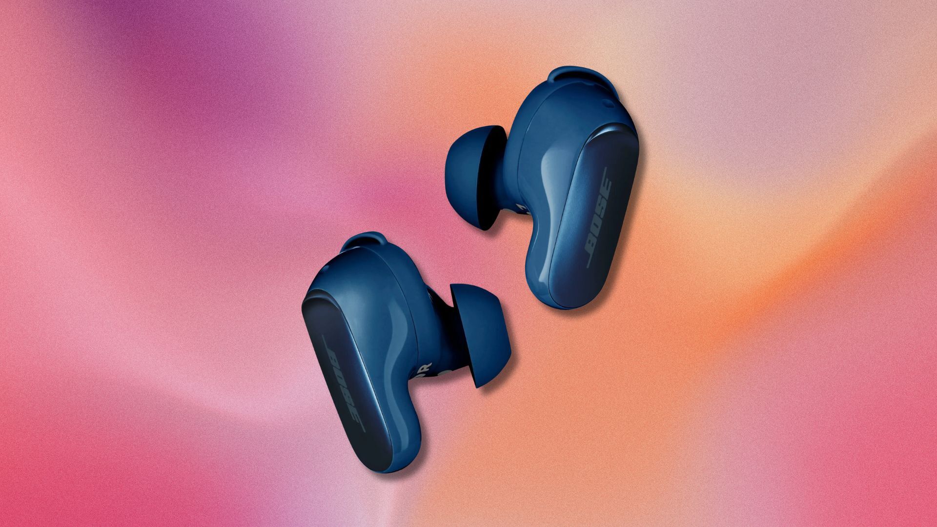 lunar blue bose quietcomfort ultra earbuds against a pink and orange swirling background