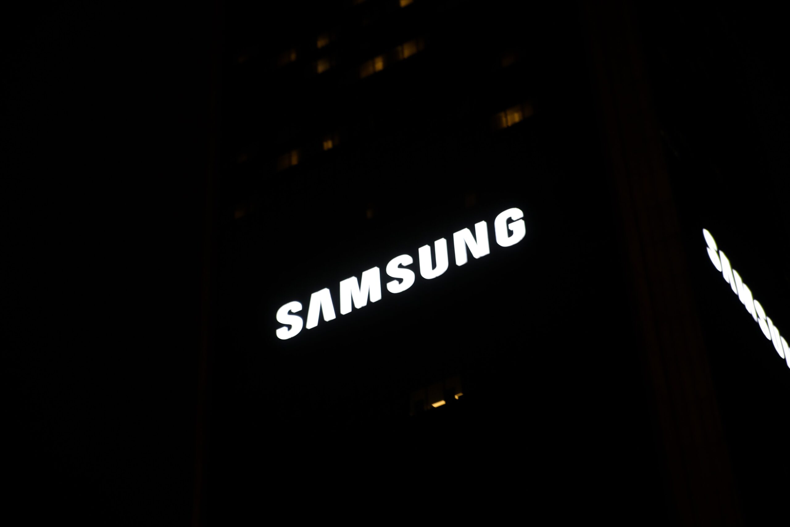 samsung logo illuminated against a black background