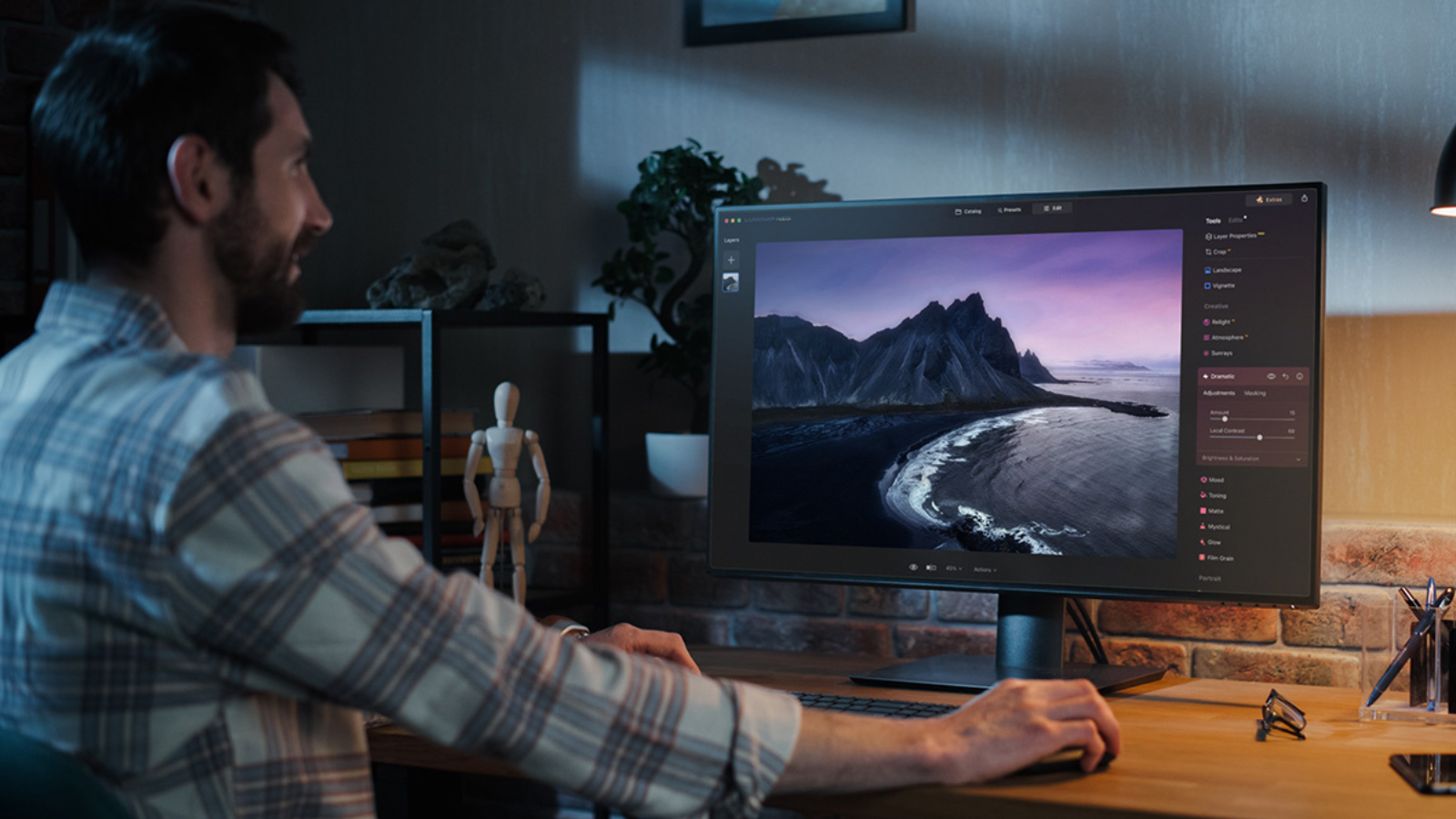 man using luminar software on desktop computer