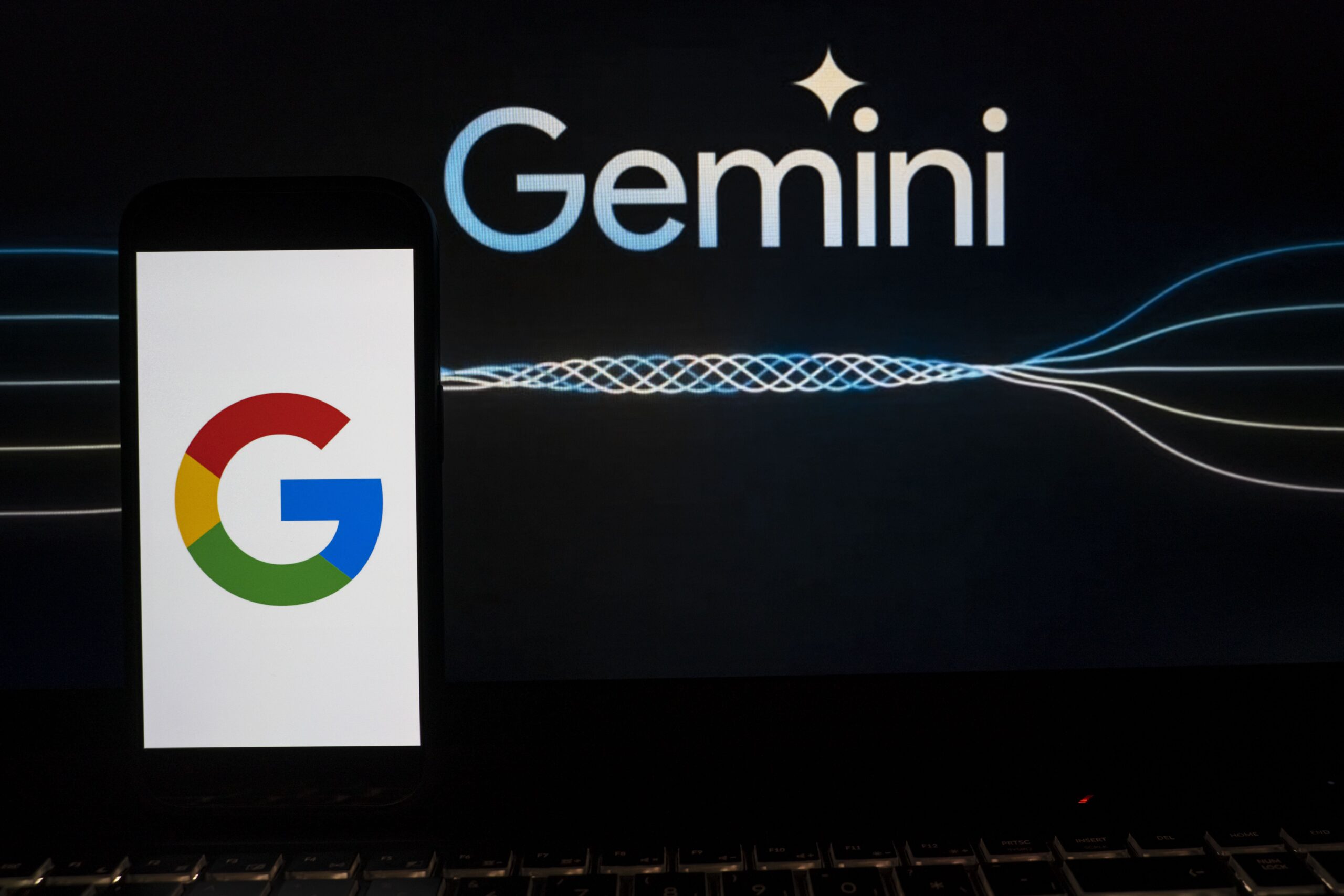 google logo on phone with the word gemini behind it