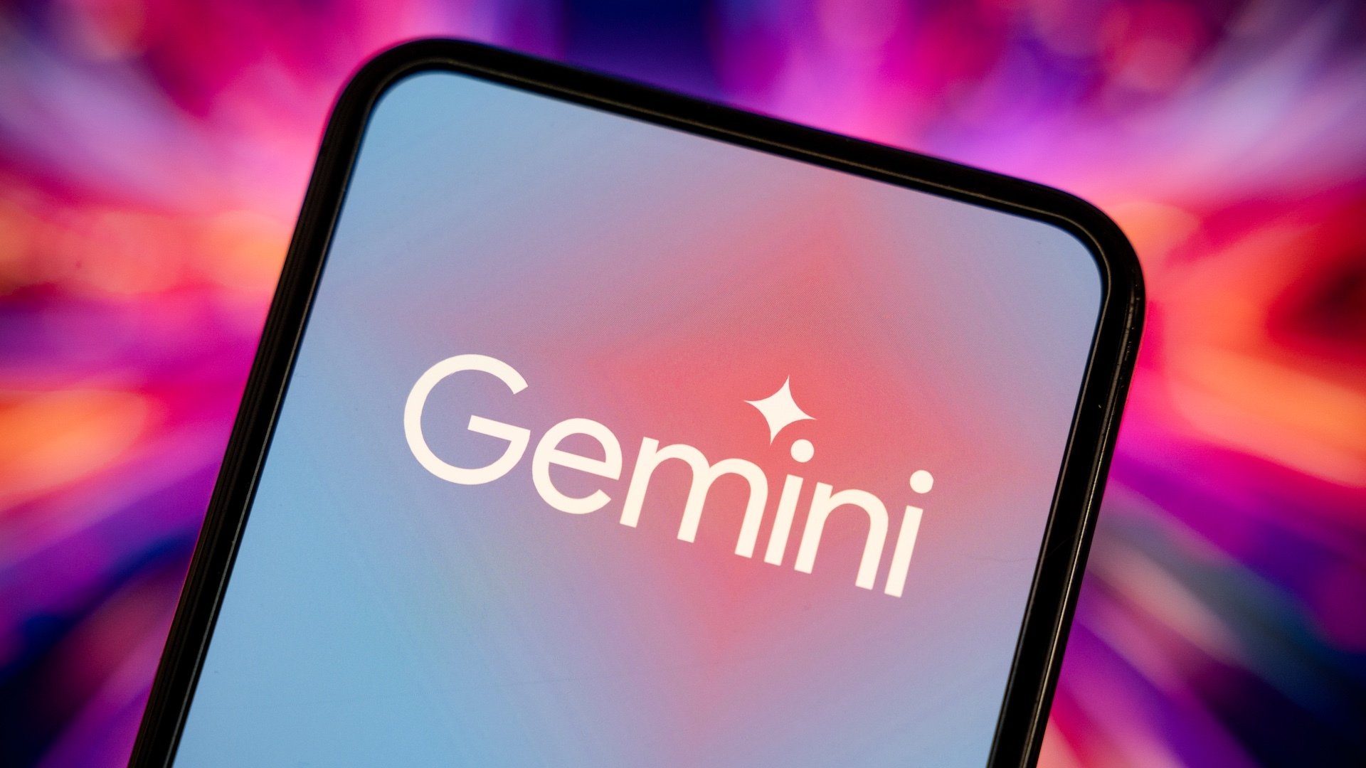 This illustration photo shows the logo of Google's artificial intelligence (AI) application, Gemini, displayed on a phone screen with a colored background of blue and pink.