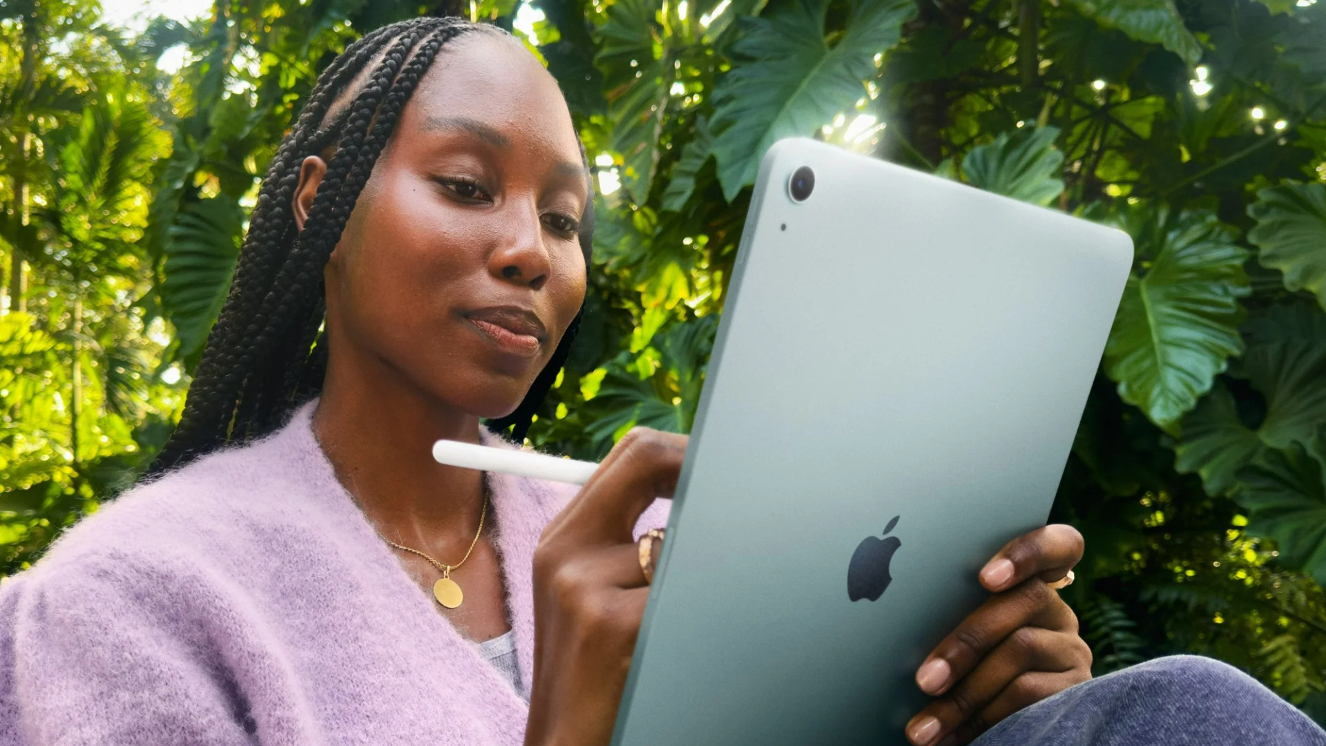 A person holding an iPad Air.