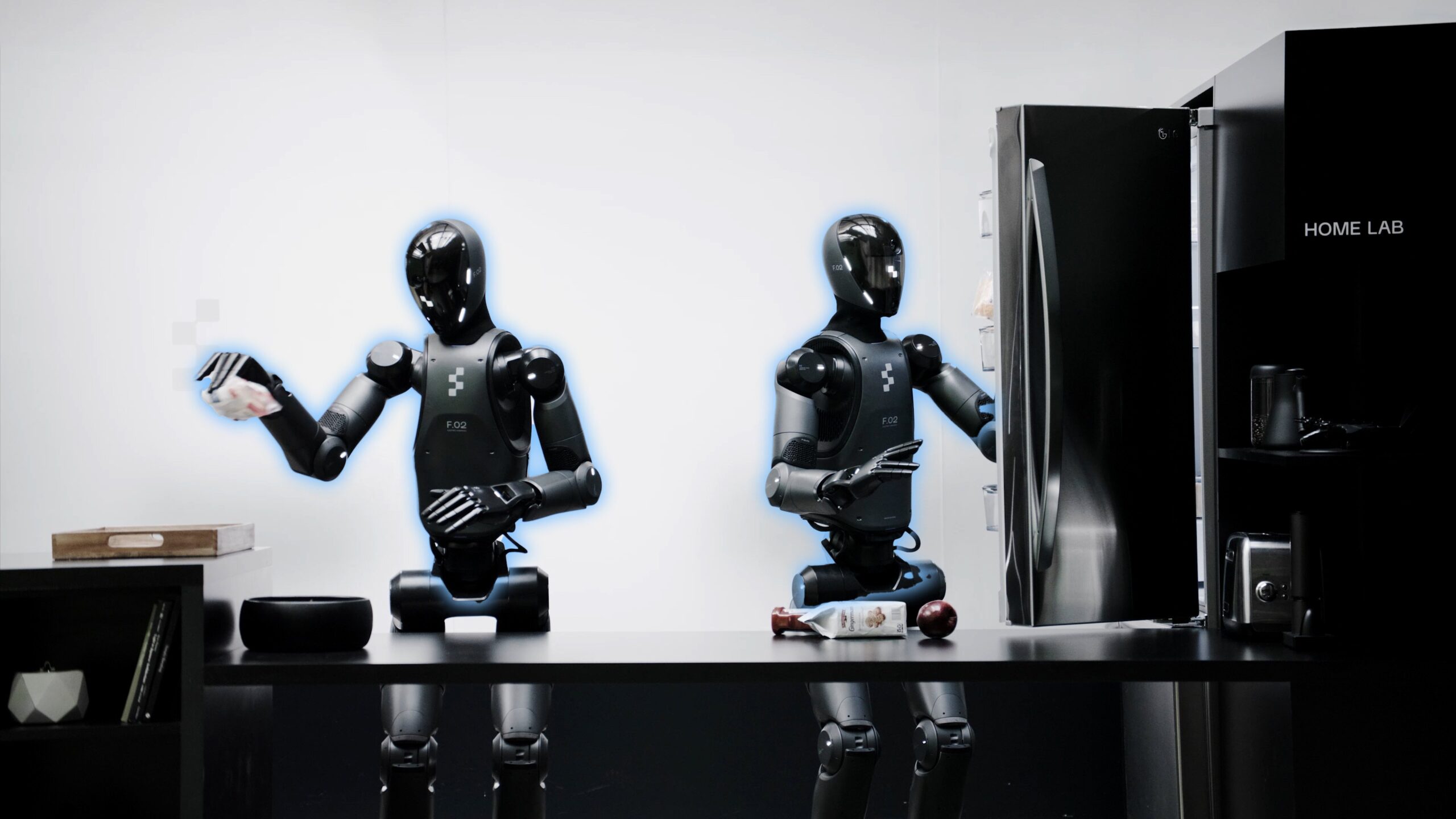 Figure's humanoid robots working together to put away groceries