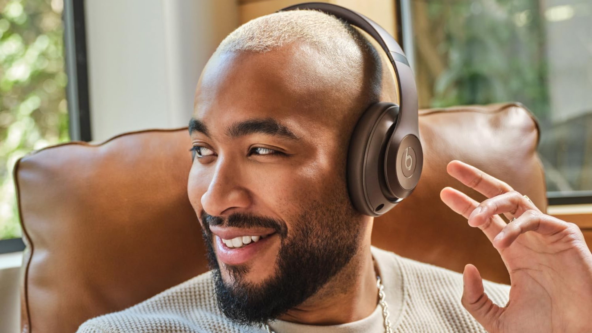 A person wearing a pair of Beats Studio Pro headphones.