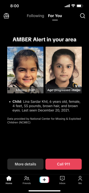 A screenshot of an Amber Alert on a TikTok FYP. The screen shows side by side photos of a child with identifying information below it, as well as two buttons that read "more details" and "call 911".