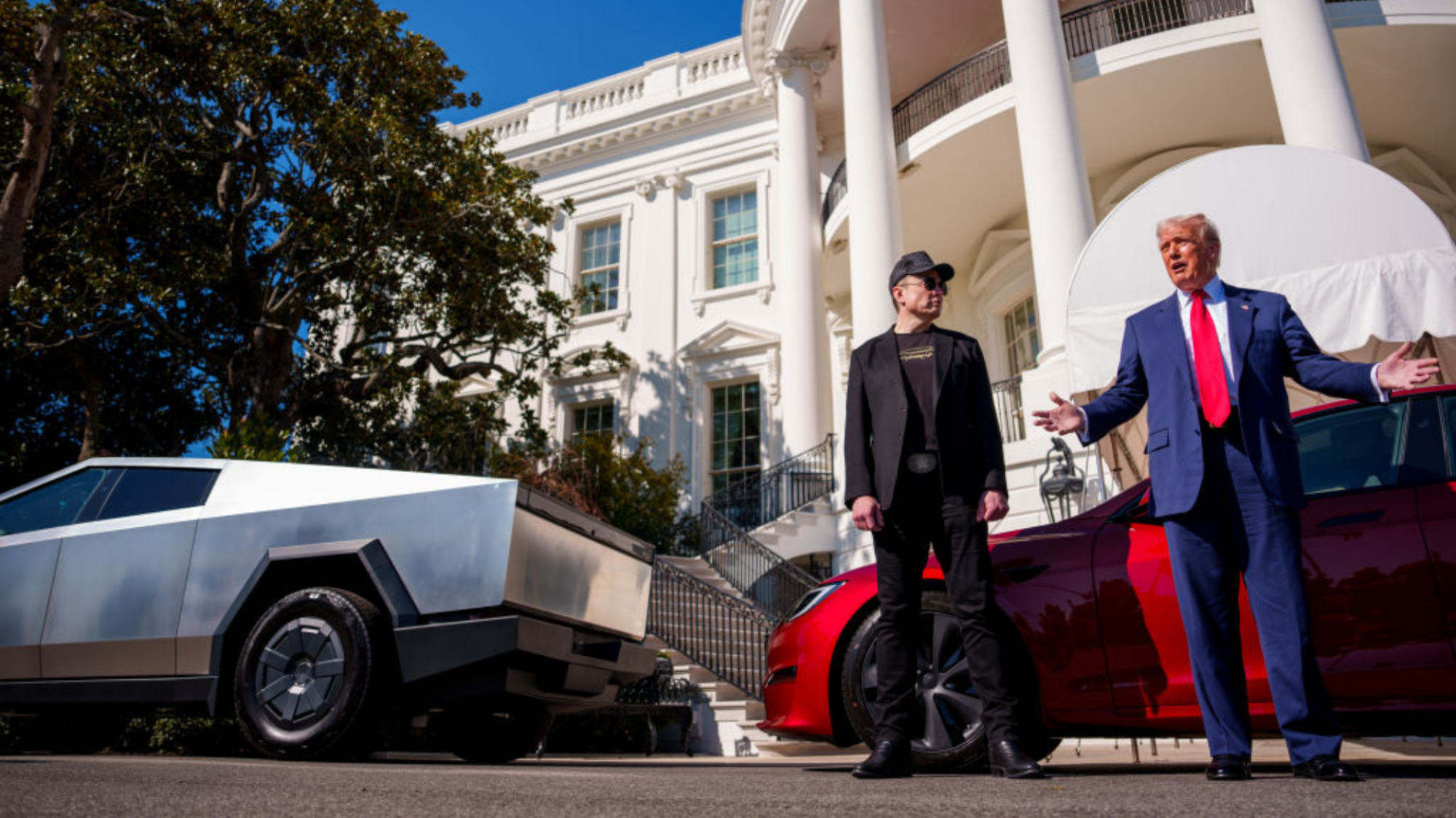 U.S. President Donald Trump, accompanied by White House Senior Advisor, Tesla and SpaceX CEO Elon Musk, speaks next to a Tesla Cyber Truck and a Model S on the South Lawn of the White House on March 11, 2025 in Washington, DC.