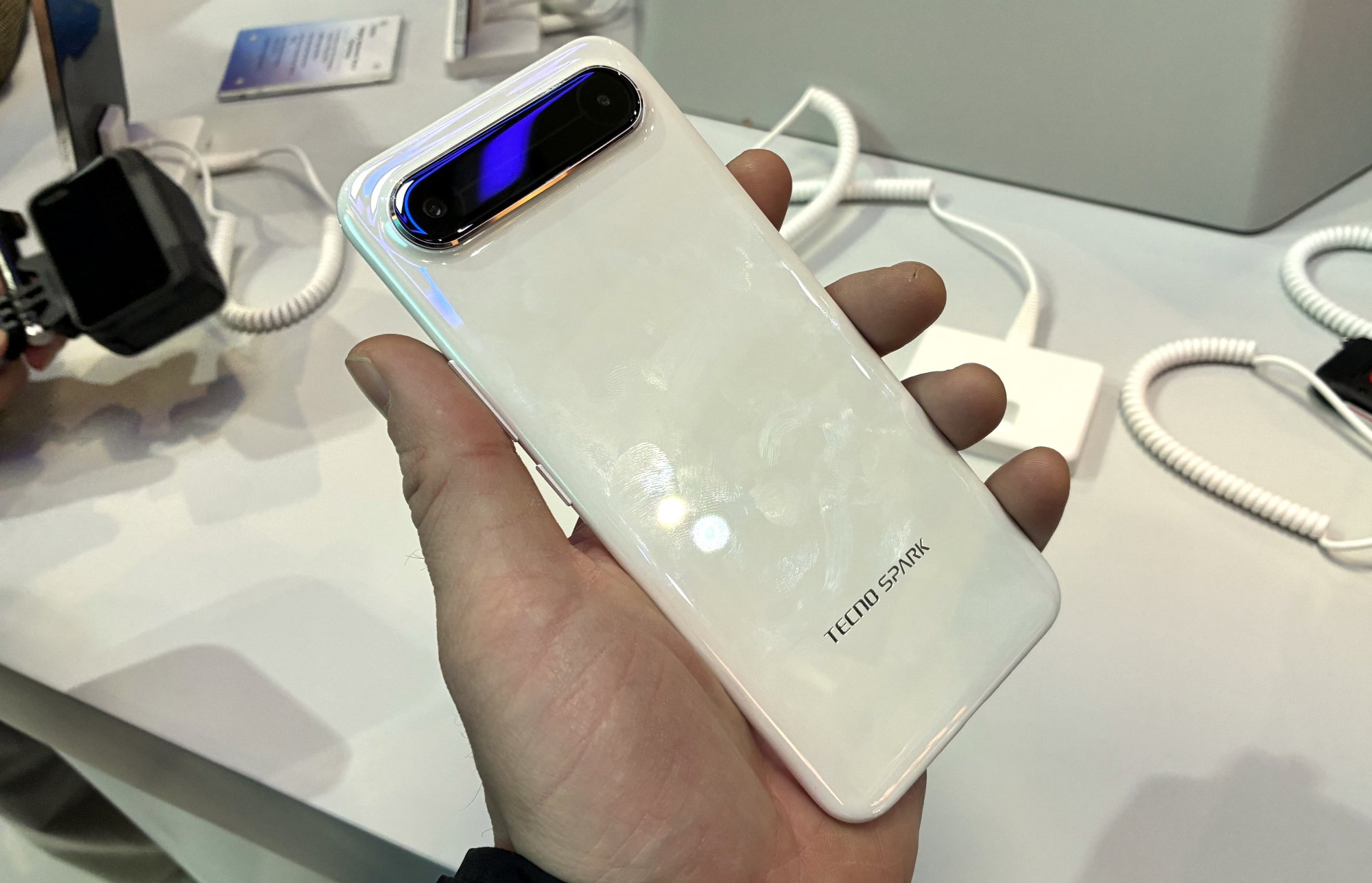 The back of the Tecno Spark Slim smartphone shown in a person's hand.