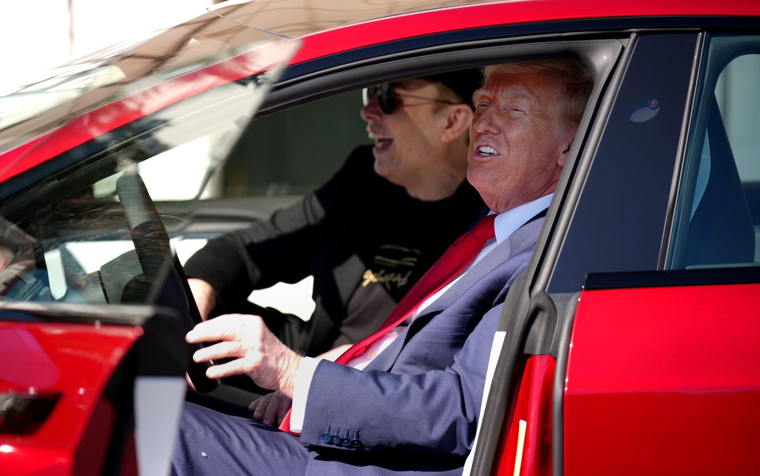 Donald Trump and Elon Musk inside of a Tesla outside the white house