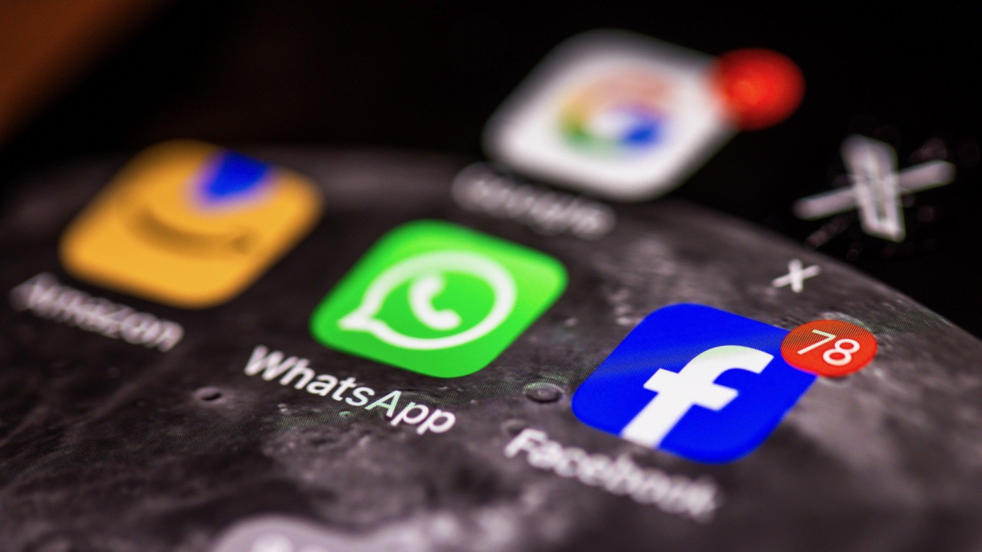 facebook, whatsapp, x, and google app icons on smartphone screen