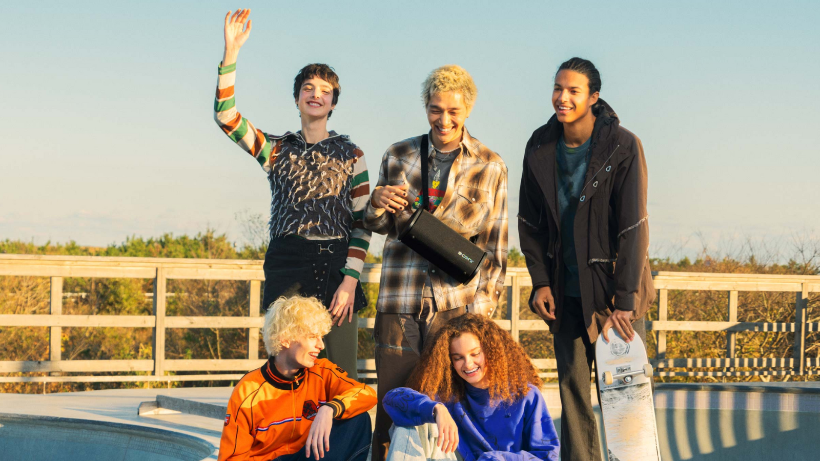 group of friends outside listening to the Sony ULT Field 5 speaker