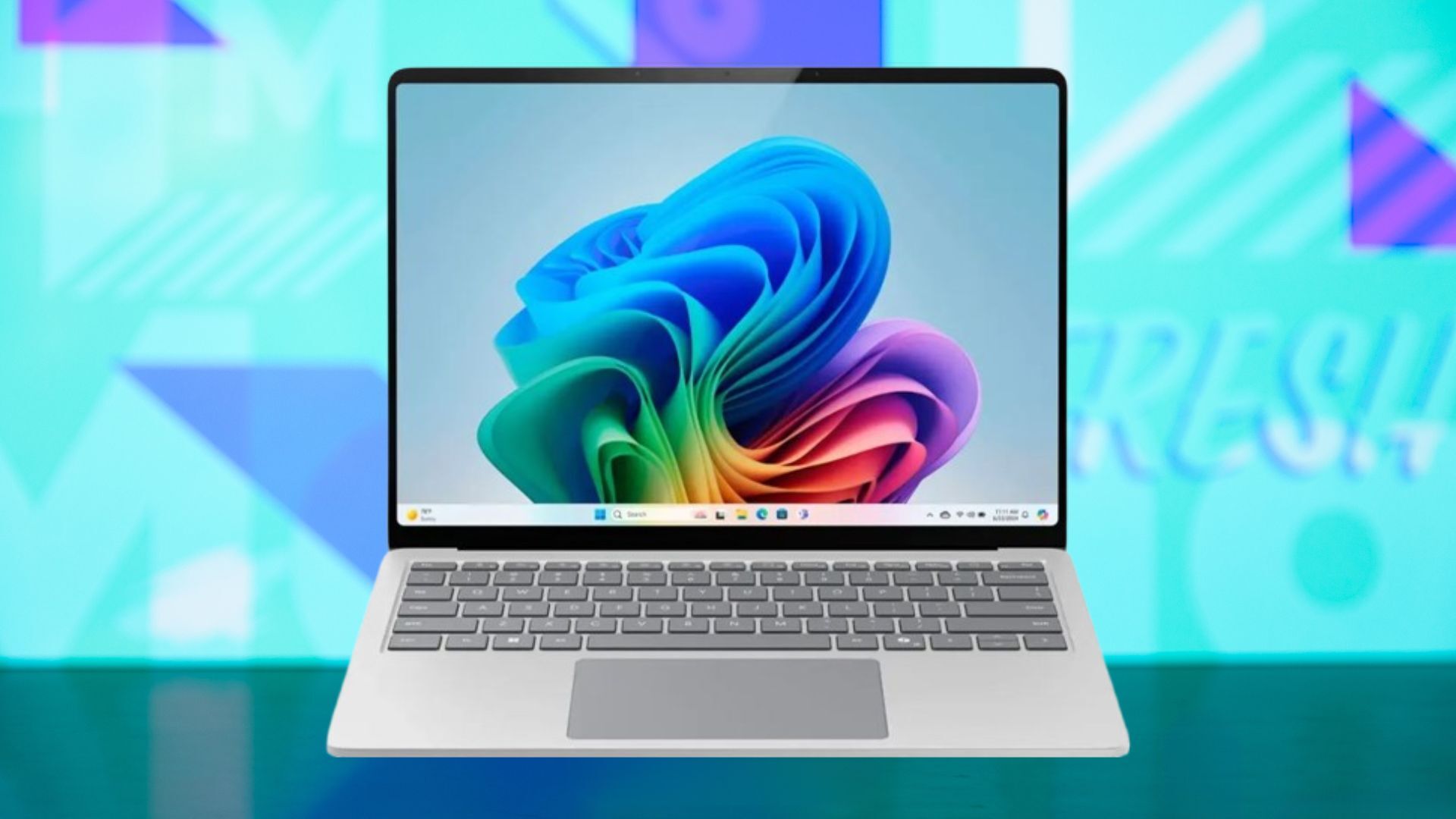 A Microsoft Surface Laptop appears with an abstract screen image and background.