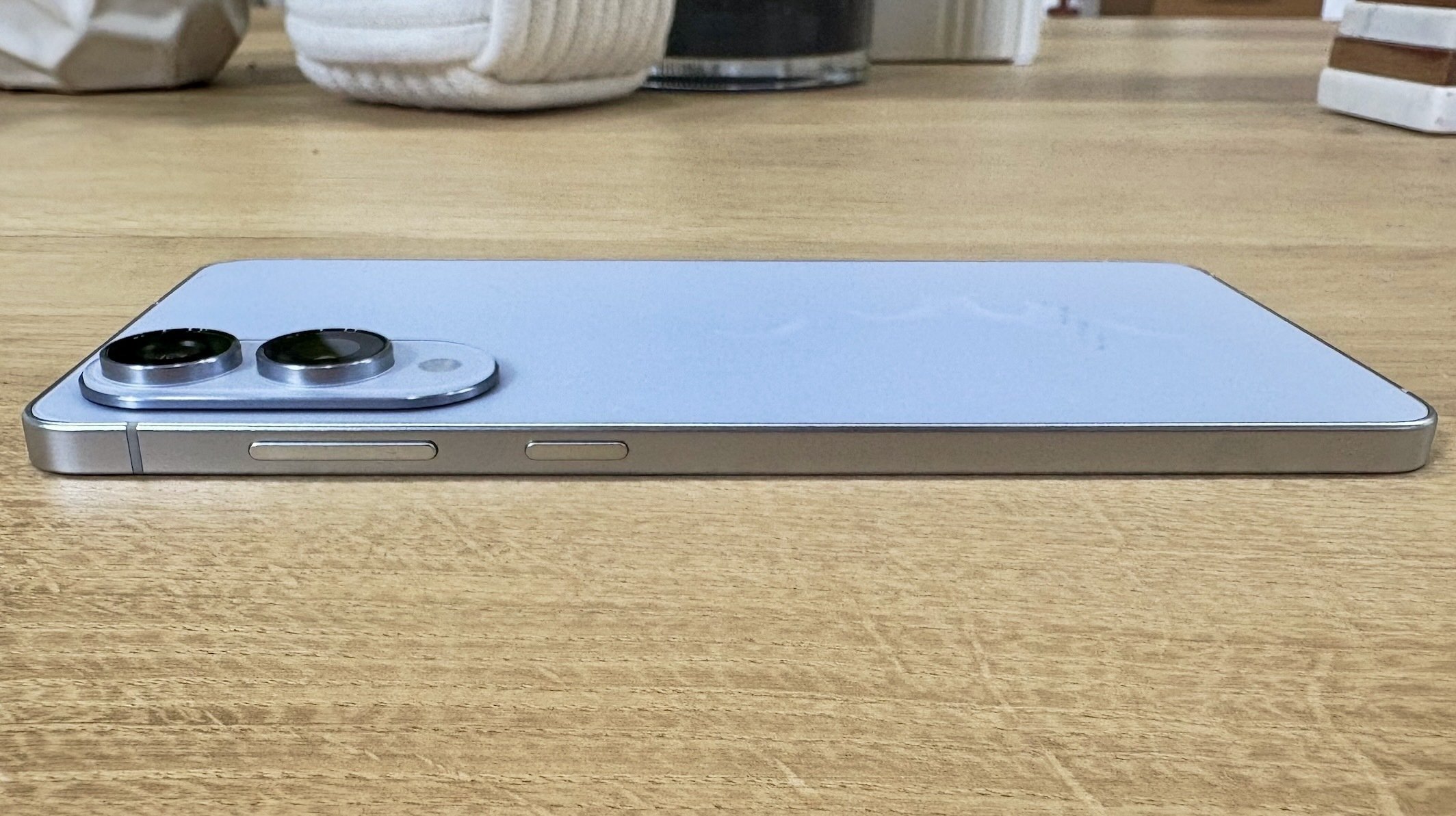 samsung galaxy s25 edge smartphone on wood floor