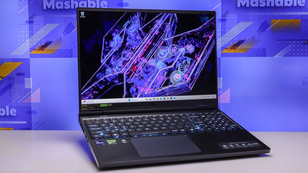 the acer predator helios 16 laptop open against a purple background