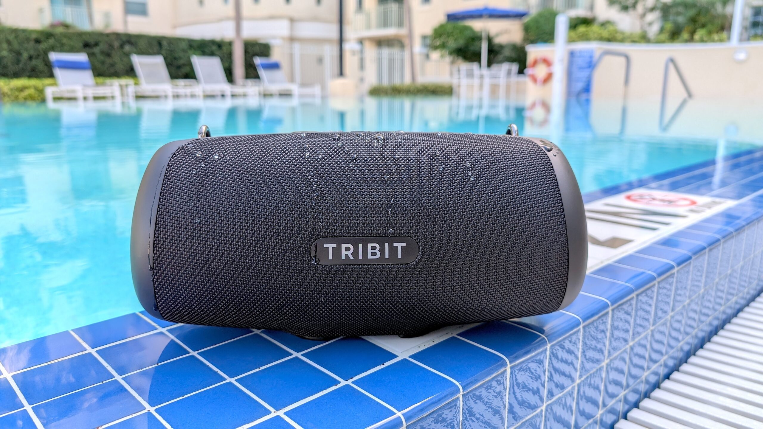 tribit speaker sitting on pool ledge