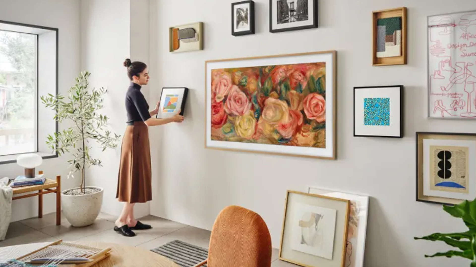 A person looking at a gallery wall with a Samsung Frame TV
