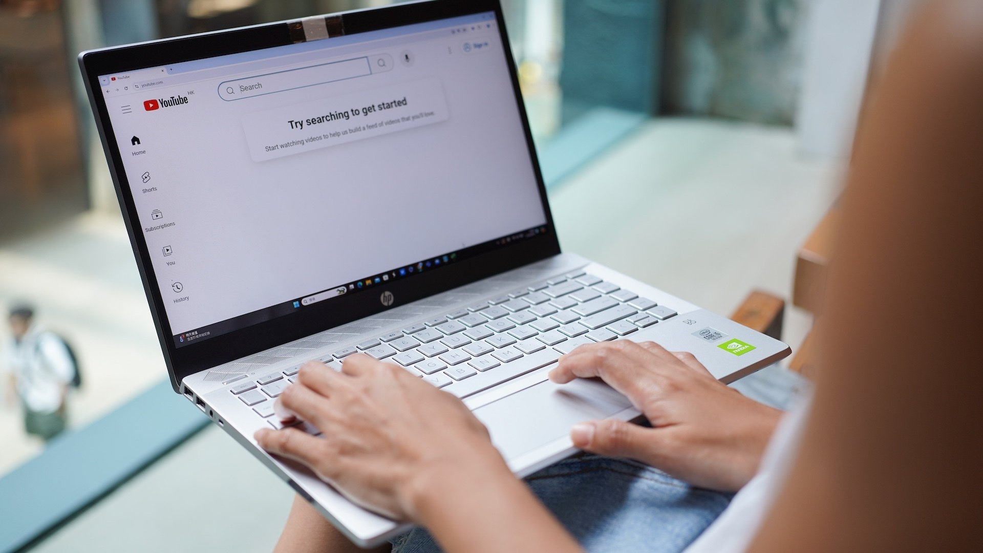A woman browses Youtube website on her laptop.